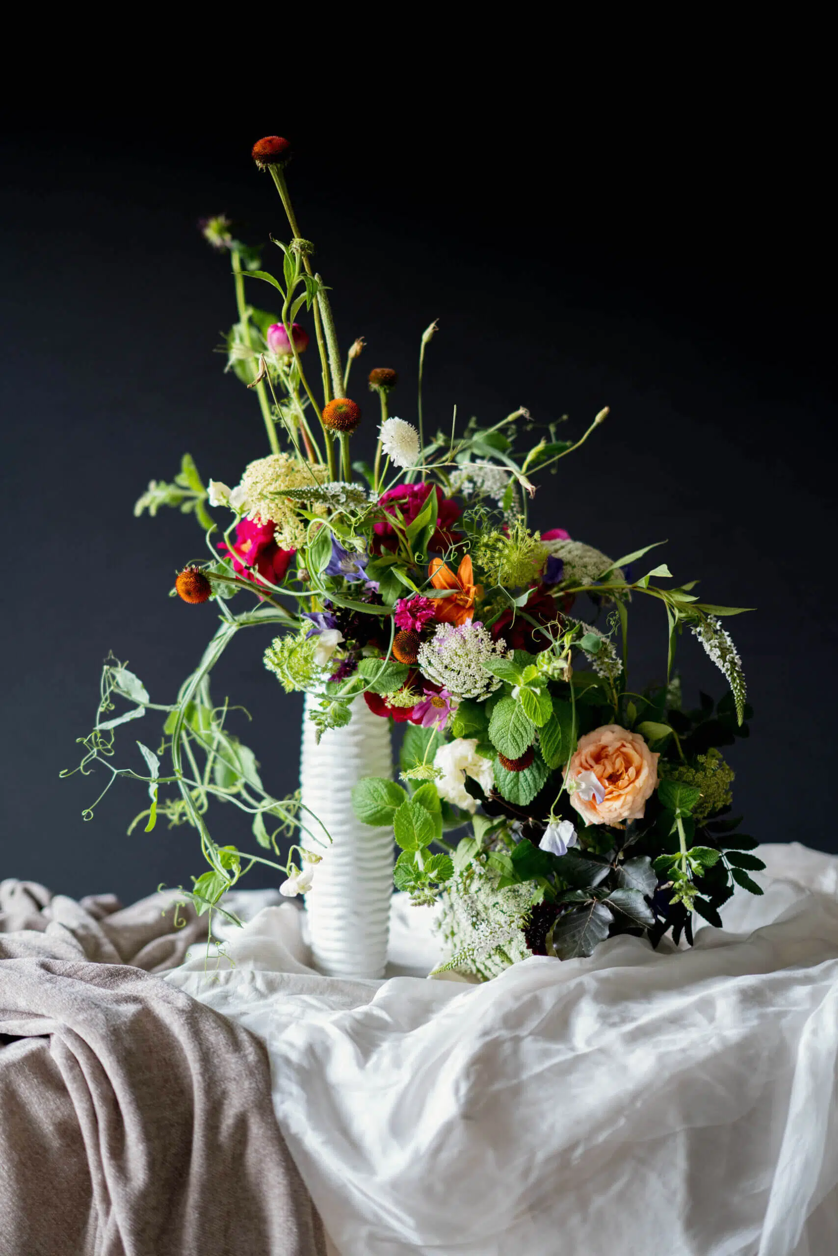 Blooming haus, a guide to wedding flower arrangements, asymmetrial wedding centrepiece