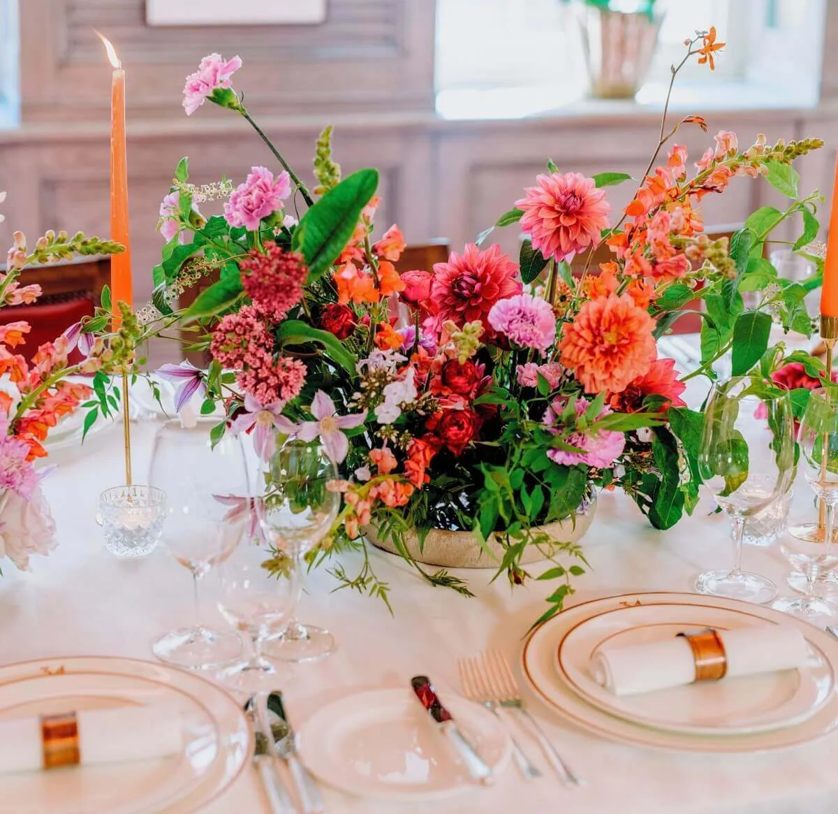 Floral centrepiece with red, pink, and orange flowers