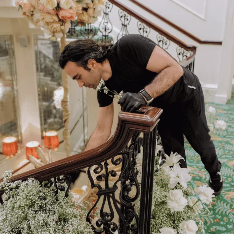 A man working on the floral designs for an event