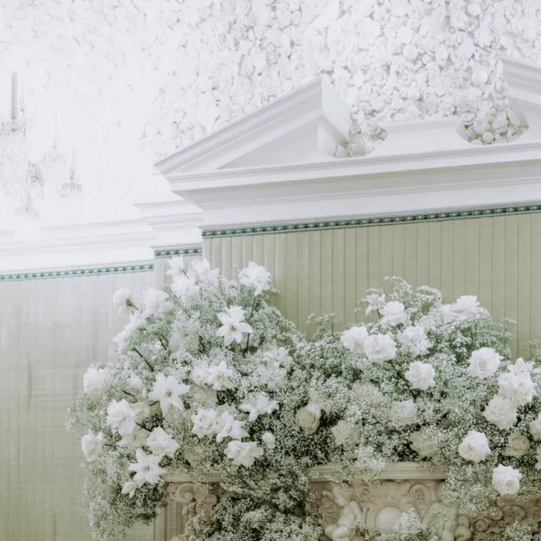 White flower on a fire surround under a cornice piece