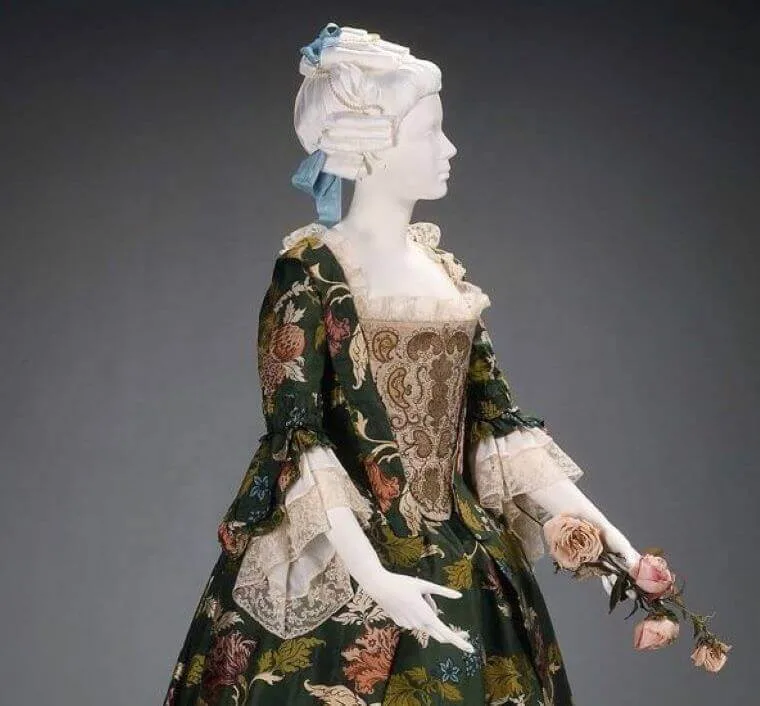 An insightful guide to flower fashion & its evolution through the ages 22 A statue wearing a floral brocade dress from the 18th century