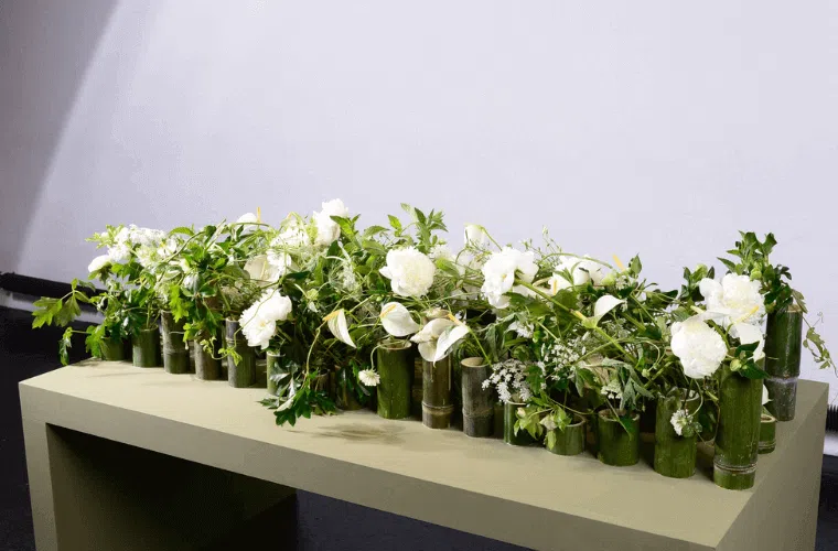 Peace lilies in a display with other white flowers and green foliage