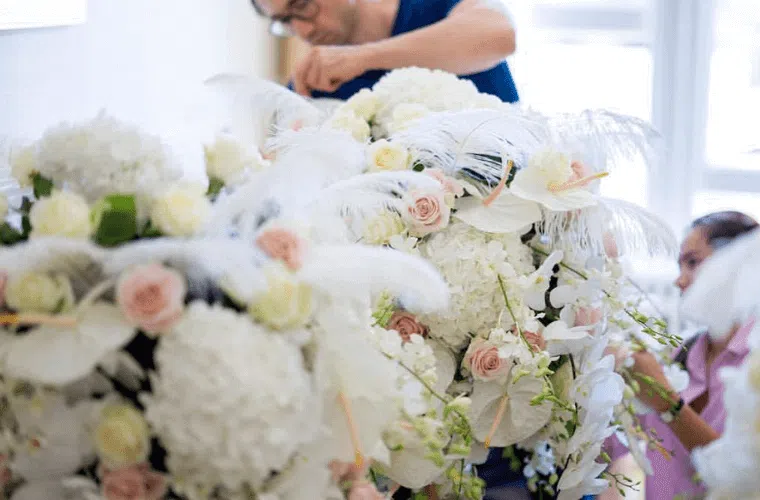 A designer from blooming haus working an a display for an event