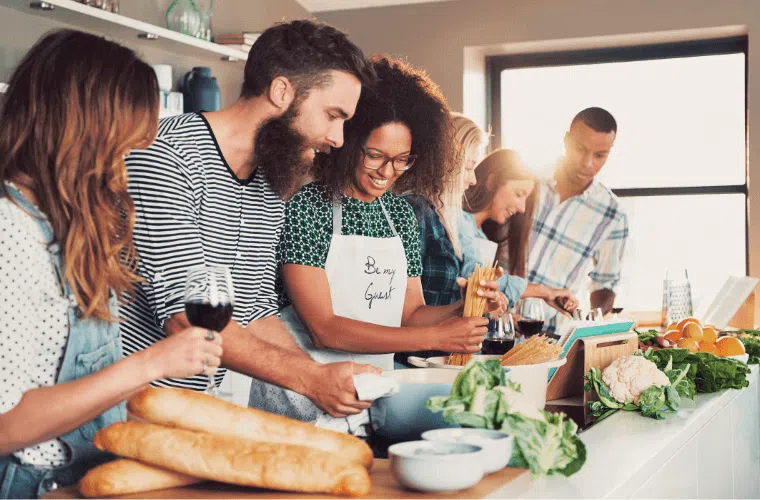 A group of male and female friends cooking