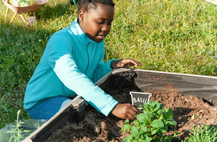 A young girl looking after plants