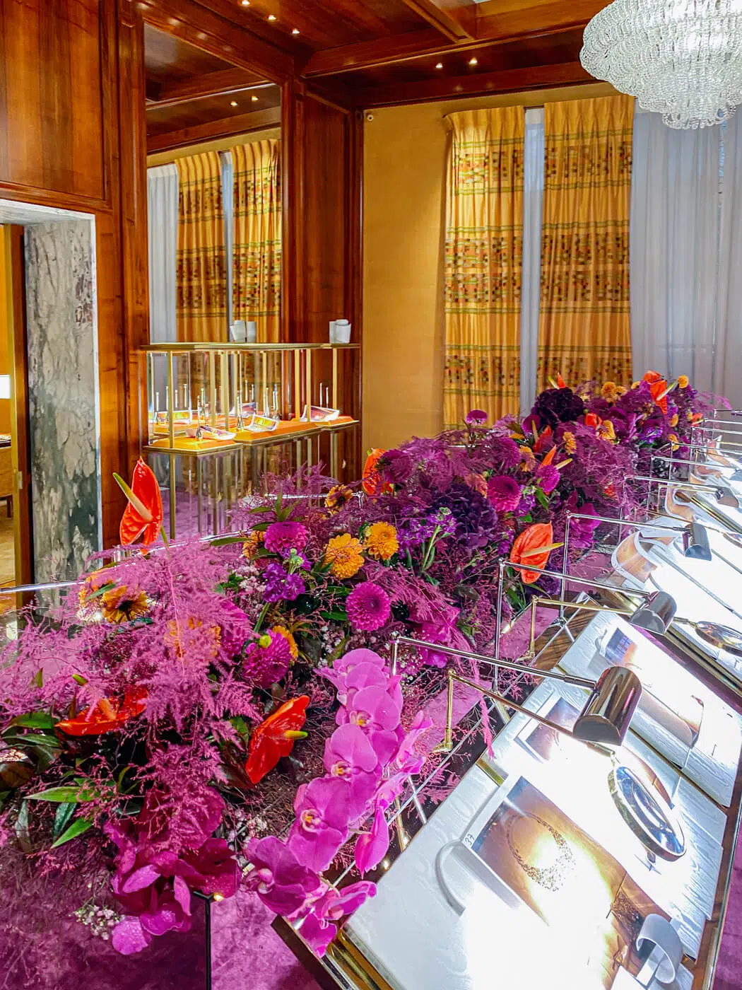 How to choose corporate event flowers – large arrangement with purple orchids, orange anthuriums and dahlias by blooming haus