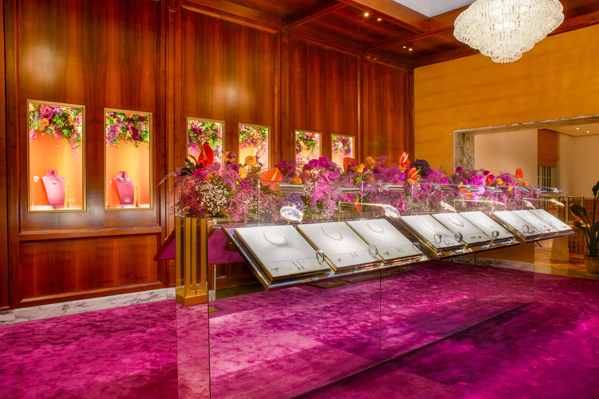 Large corporate event floral arrangement with anthuriums and purple orchids by blooming haus