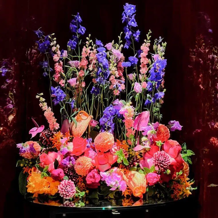 How can my business help fight climate change in 2025? 19 A colourful floral display by blooming haus with purple, pink, and orange blooms