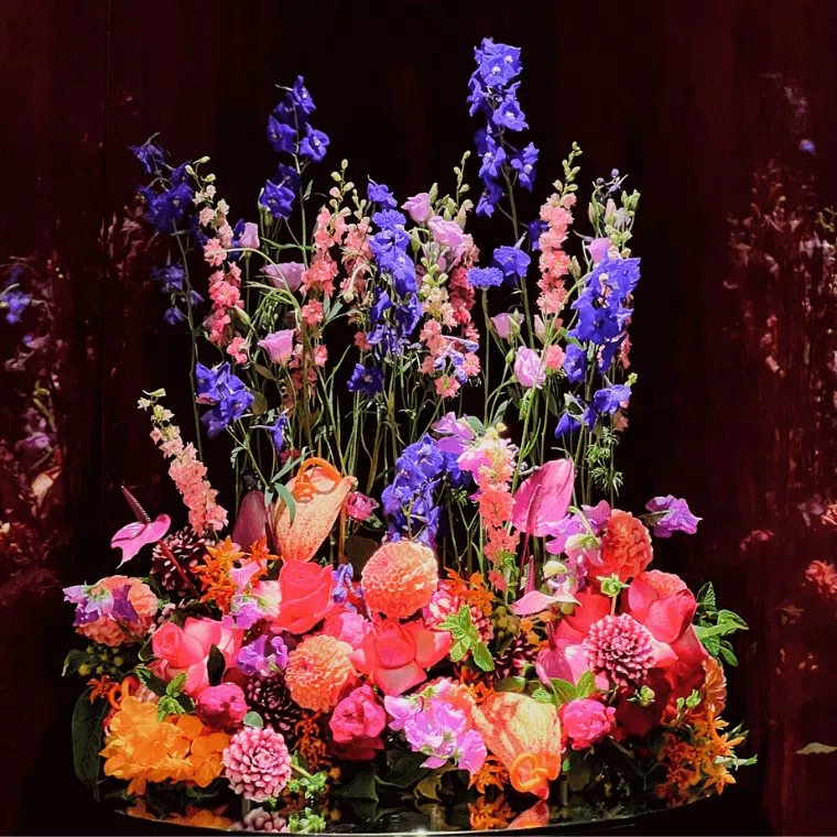 A bright floral display with orange, purple, and pink flowers
