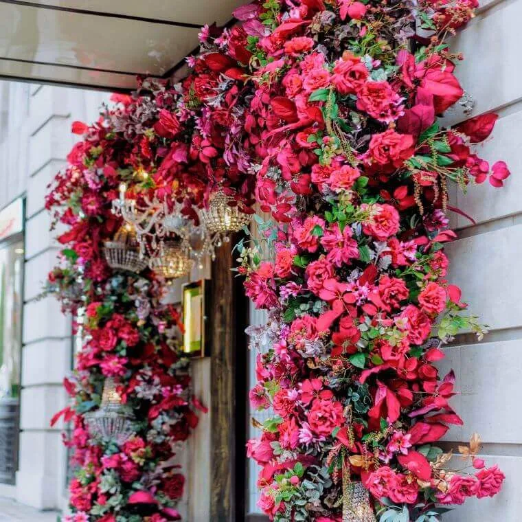 Side view of a bold coloured red and green flower arch