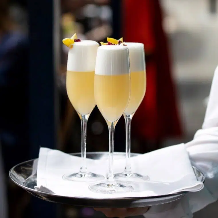 Weddings at daphne's london | our honest review 2025 6 Three orange and white cocktails on a tray