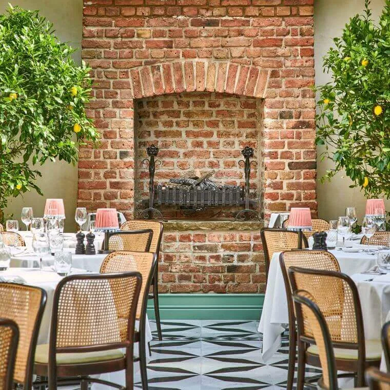 Weddings at daphne's london | our honest review 2025 12 Brick fireplace focal point at daphne's restaurant