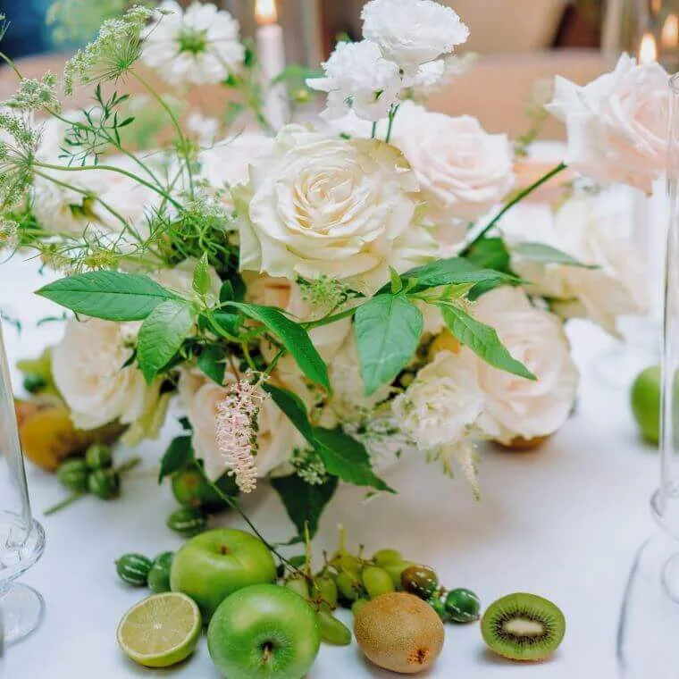 Weddings at daphne's london | our honest review 2025 15 Pastel coloured floral display including items of fruit such as apples and kiwi fruit