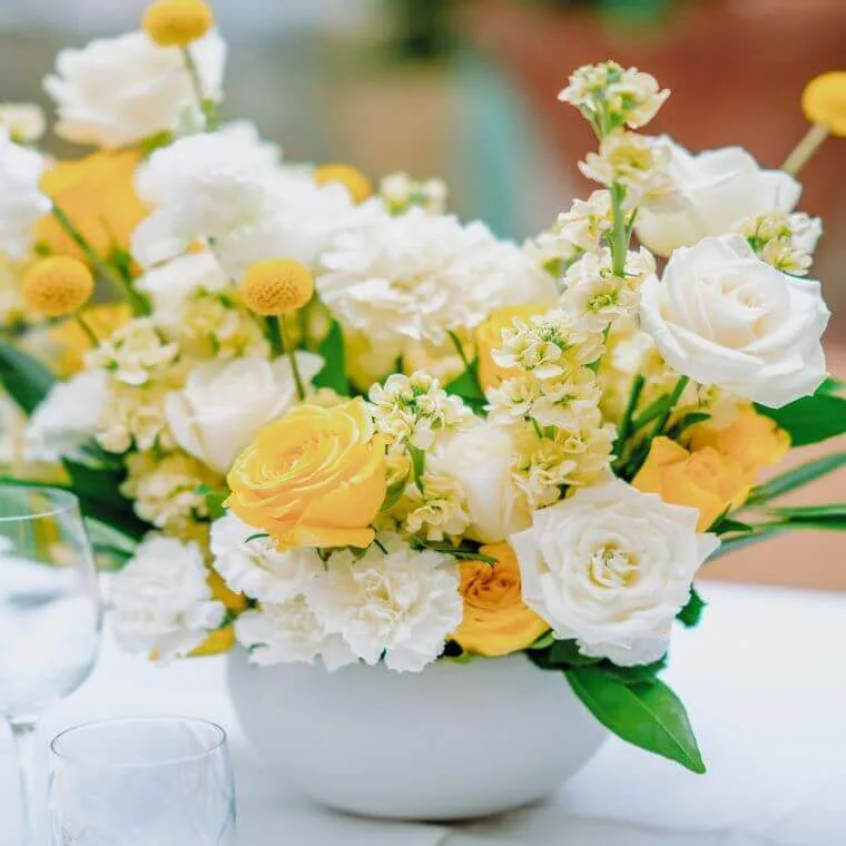 Weddings at daphne's london | our honest review 2025 14 A floral display with yellow and white roses and carnations