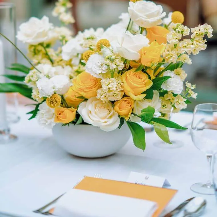 Weddings at daphne's london | our honest review 2025 13 Yellow and white floral display next to a place setting