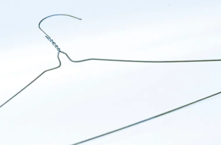 A wire coat hanger shaped into a circle for use as a wreath base