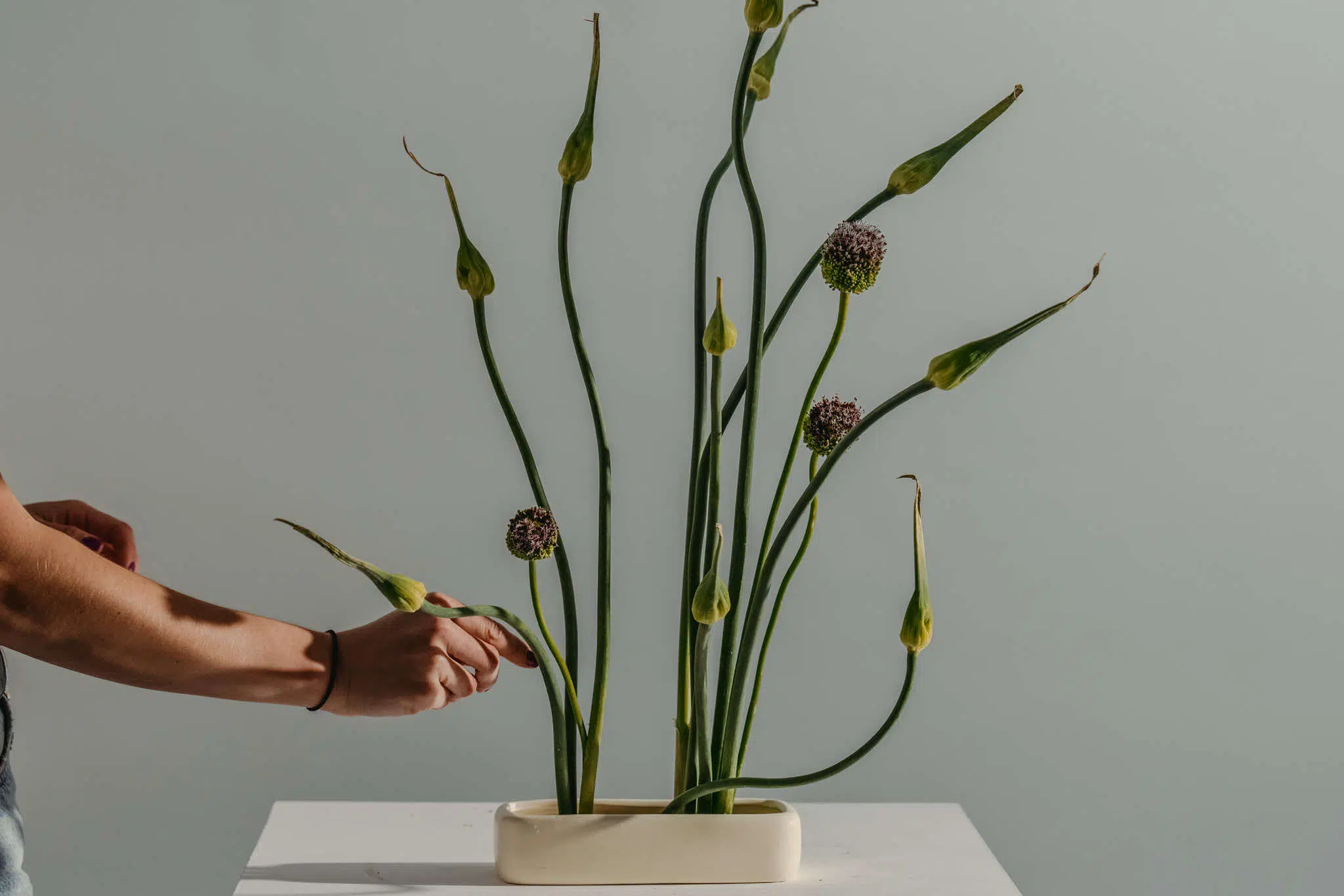 Foam-free sustainable wedding flower arrangement using organically grown alliums on a kenzan pin frog