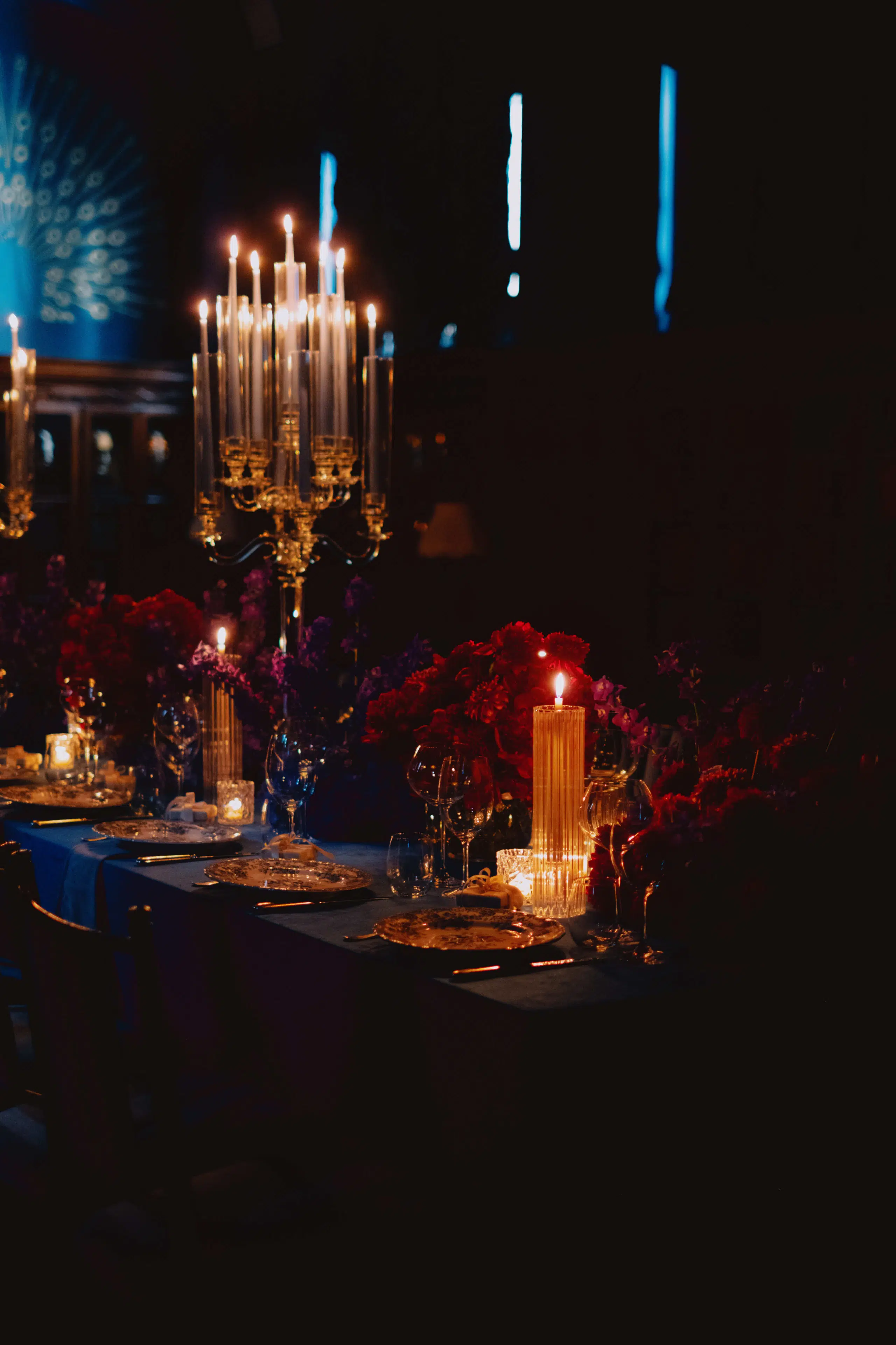 A table set up composed of hydrangeas and peonies with crystal candle holders.