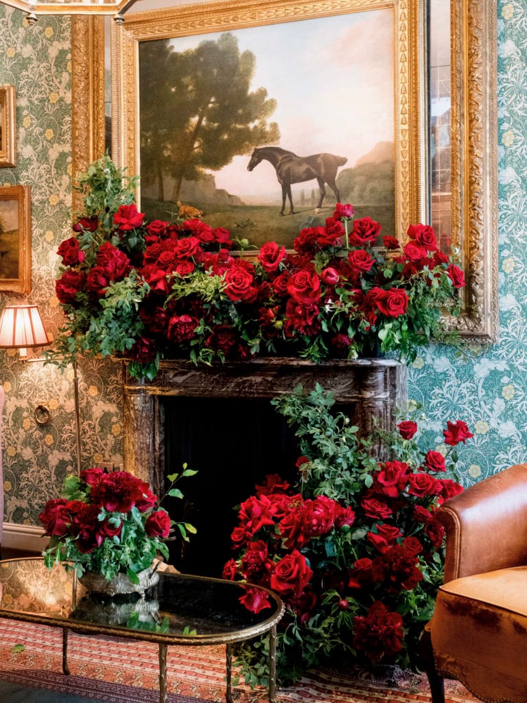 Luxurious floral arrangement in a fireplace.